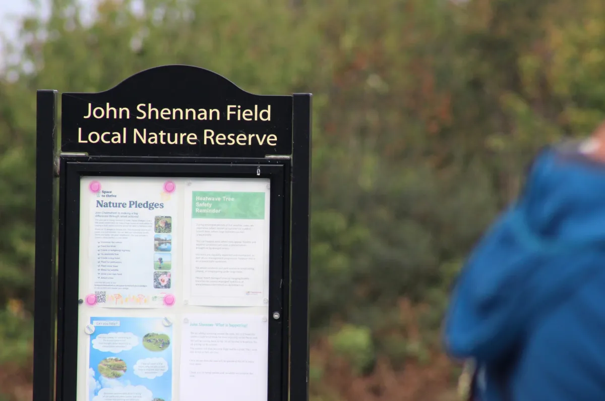 The noticeboard at the entrance to John Shennan Field Local Nature Reserve, with nature pledge and tree safety notices pinned up.