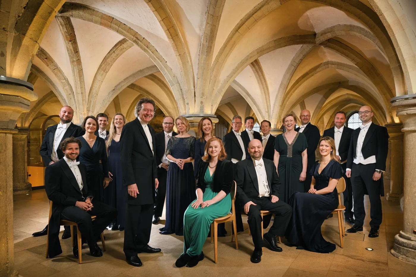 The Sixteen, a choir of men and women in black concert dress, standing together