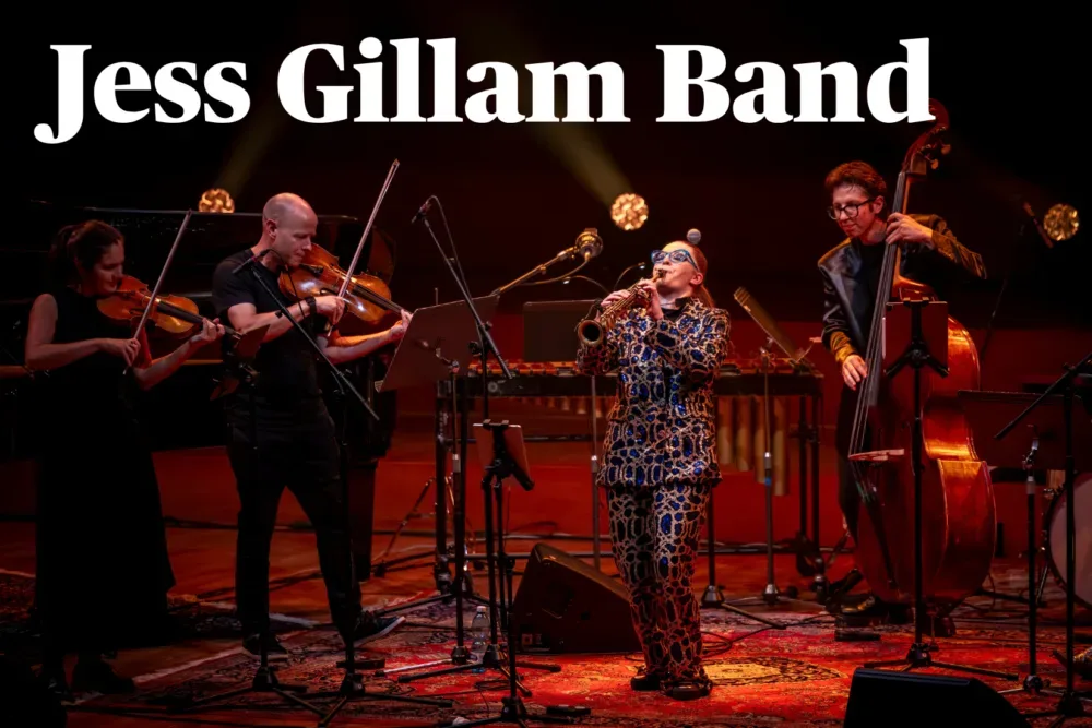 Jess Gillam playing saxophone on stage with a violinist, a viola player and a double bassist